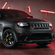 3M 2080 matt black vinyl wrap installed on a Jeep SUV in a dimly lit garage with red lights.