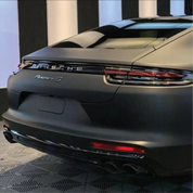 Back view of a Porsche Panamera 4S car in a showroom setting with 3M 2080 matt black wrap installed 
