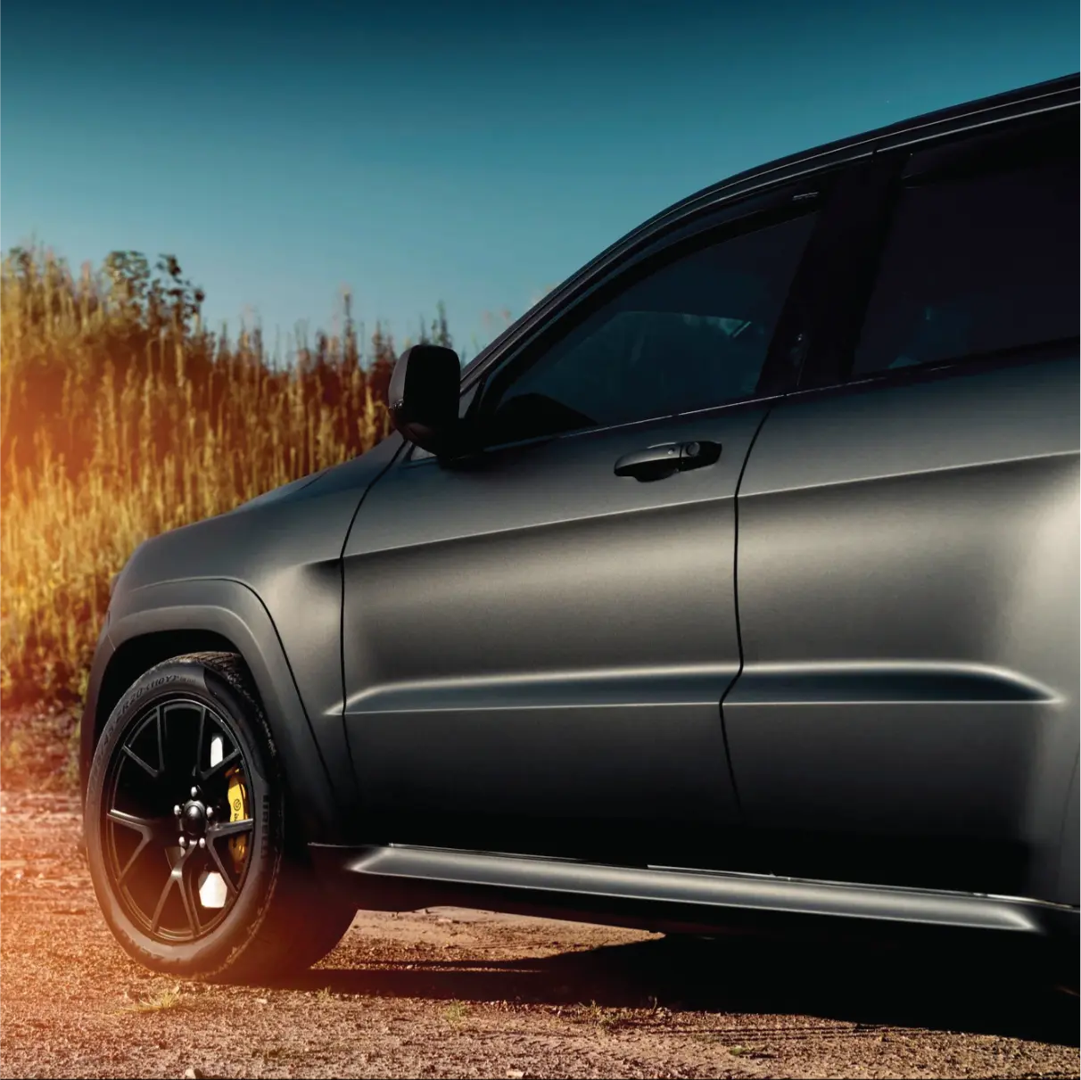 3M 2080 matt black vehicle wrap on an  SUV parked on a dirt road with a scenic background