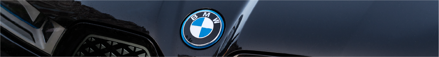 BMW window tint header showing a close up of a BMW logo on the bonnet
