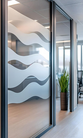 Decorative glass panel with wavy patterned window film in an office setting