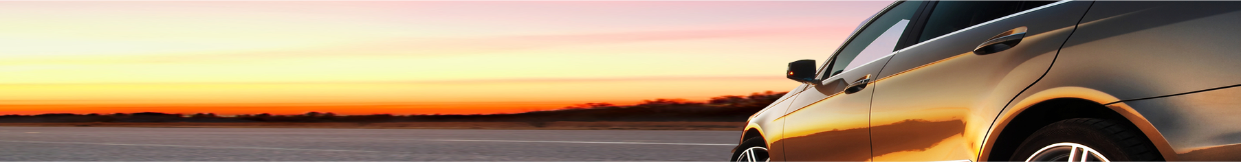 Close up of a car with tinted windows and a sunset background