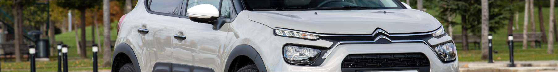 White Citroén car parked on a road with Citroen window tints installed