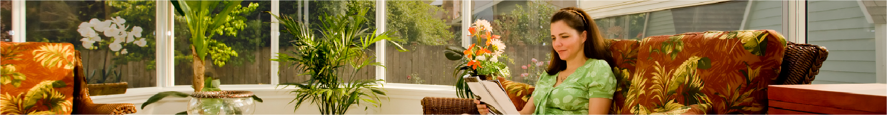 Conservatory window film installed on conservatory windows with a women inside reading a book