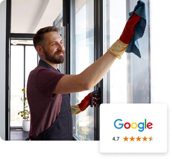 Home window tinter cleaning the glass after completing the installation.