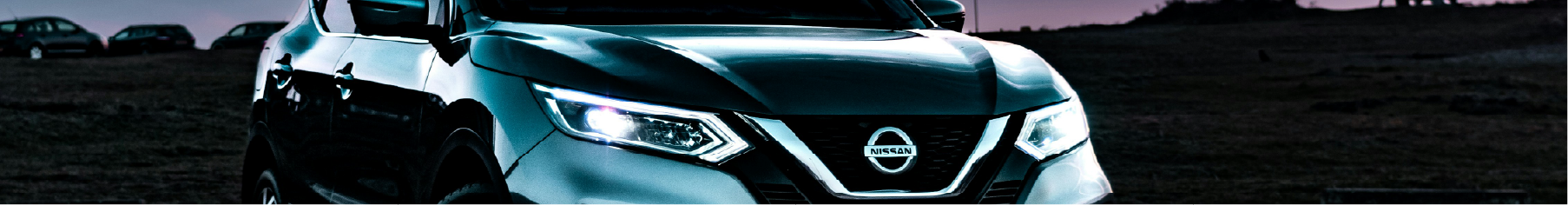 Nissan car featuring freshly installed Nissan window tint with a sunset background