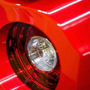 Close-up of a car's headlight with Oracol Gloss Cardinal Red installed