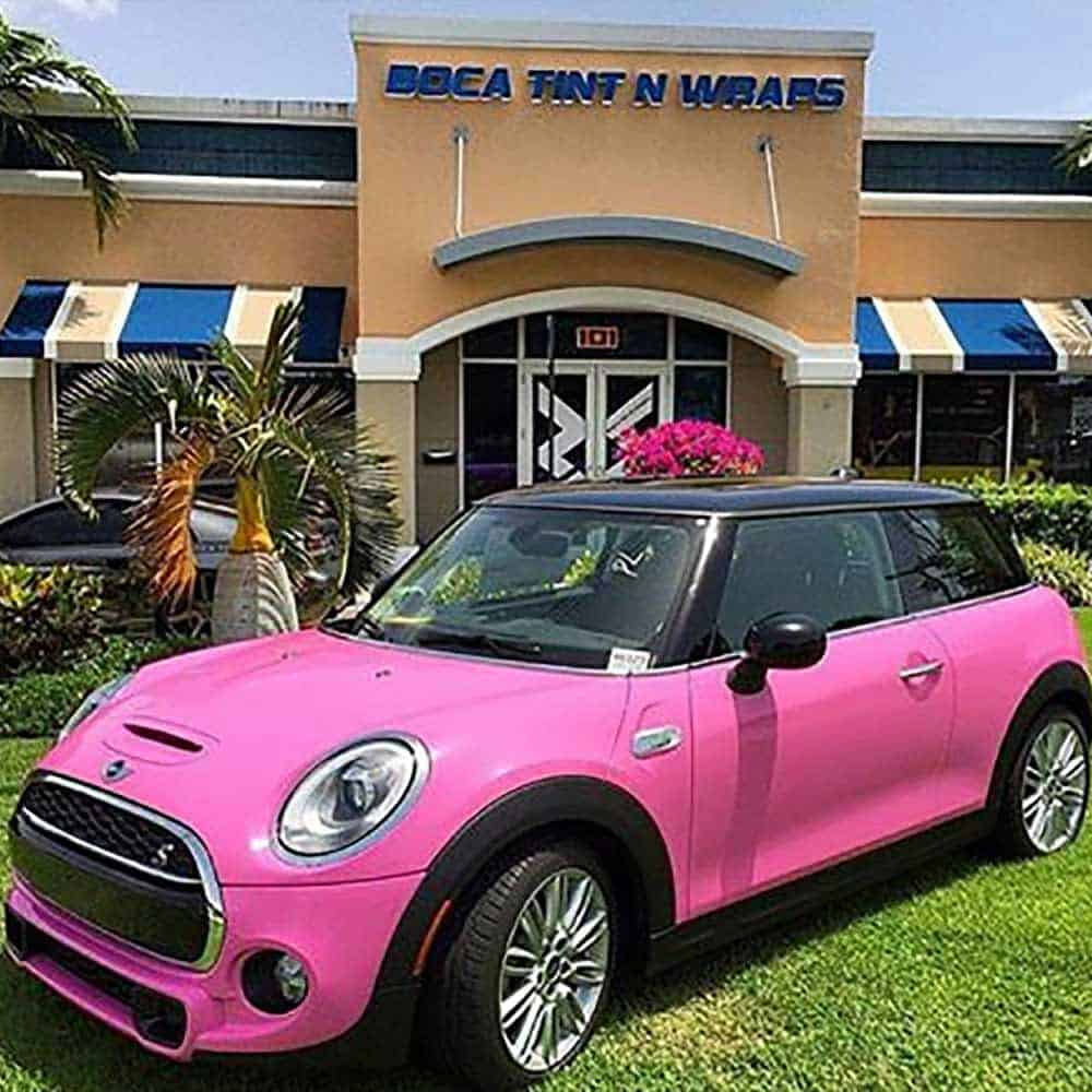 Oracal Soft Pink Mini Cooper car parked in front of a building