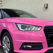 Oracal Gloss Soft Pink car with Audi logo on a gray background