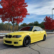 Oracal Gloss Crocus Yellow BMW car parked on a road with red trees 