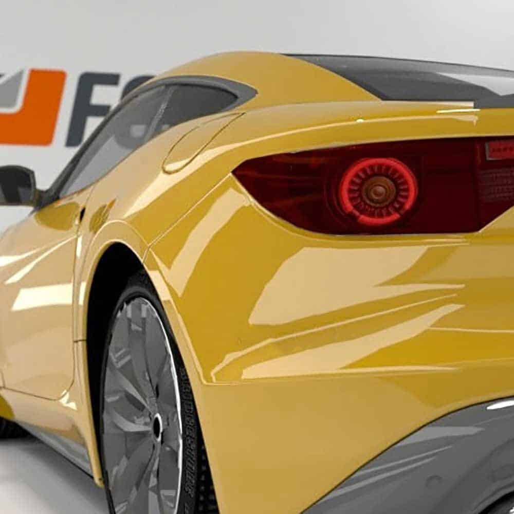 Close-up of a Gloss Maize Yellow Maserati car with a visible brand logo 