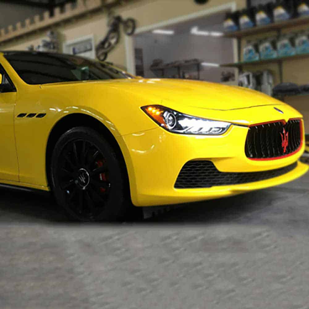 Gloss Maize Yellow Maserati car in a showroom