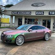 Oracal Gloss Avocado car with large wheels in front of a car accessories store