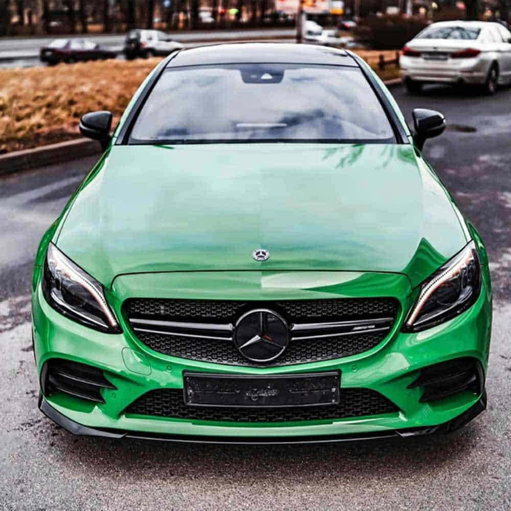 Oracal Gloss Police Green installed on a car parked on a road 