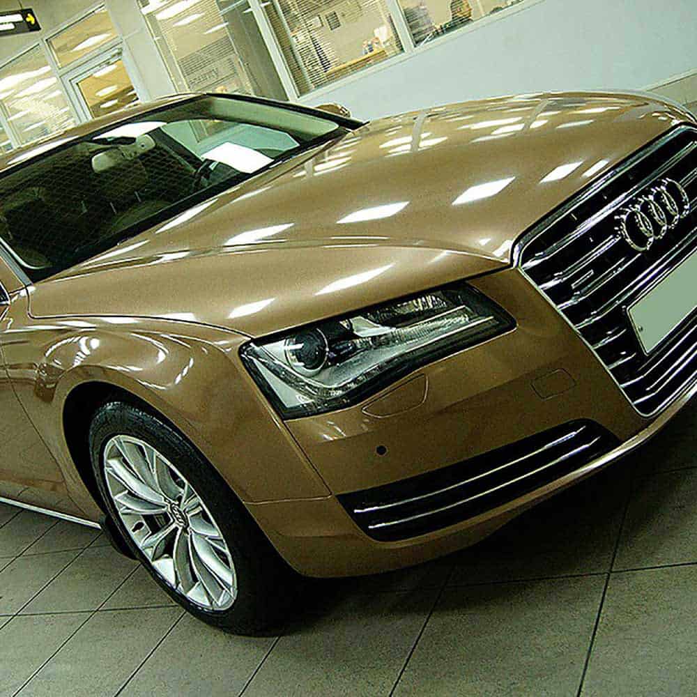 Oracal Gloss Brass Metallic Audi car in a showroom