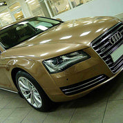 Oracal Gloss Brass Metallic Audi car in a showroom