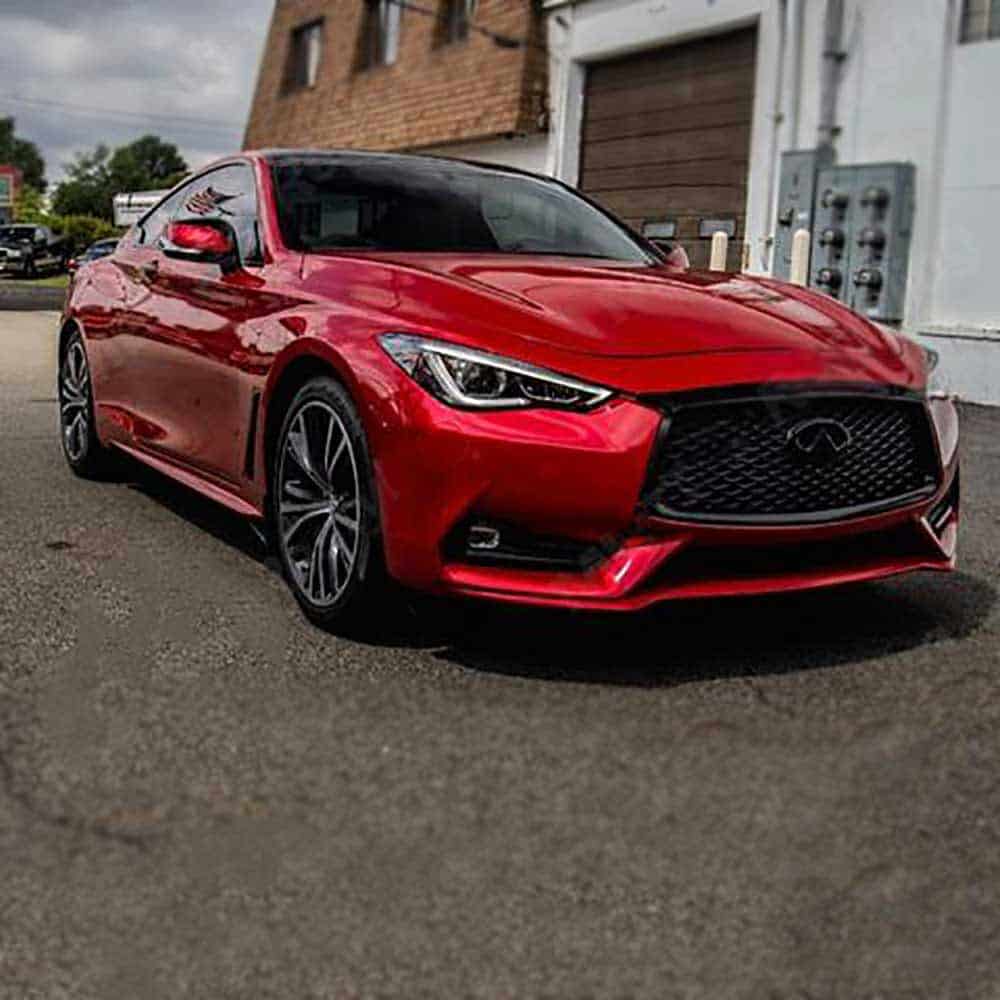 Oracal Gloss Luscious Lips installed on a car parked on a street with a building 
