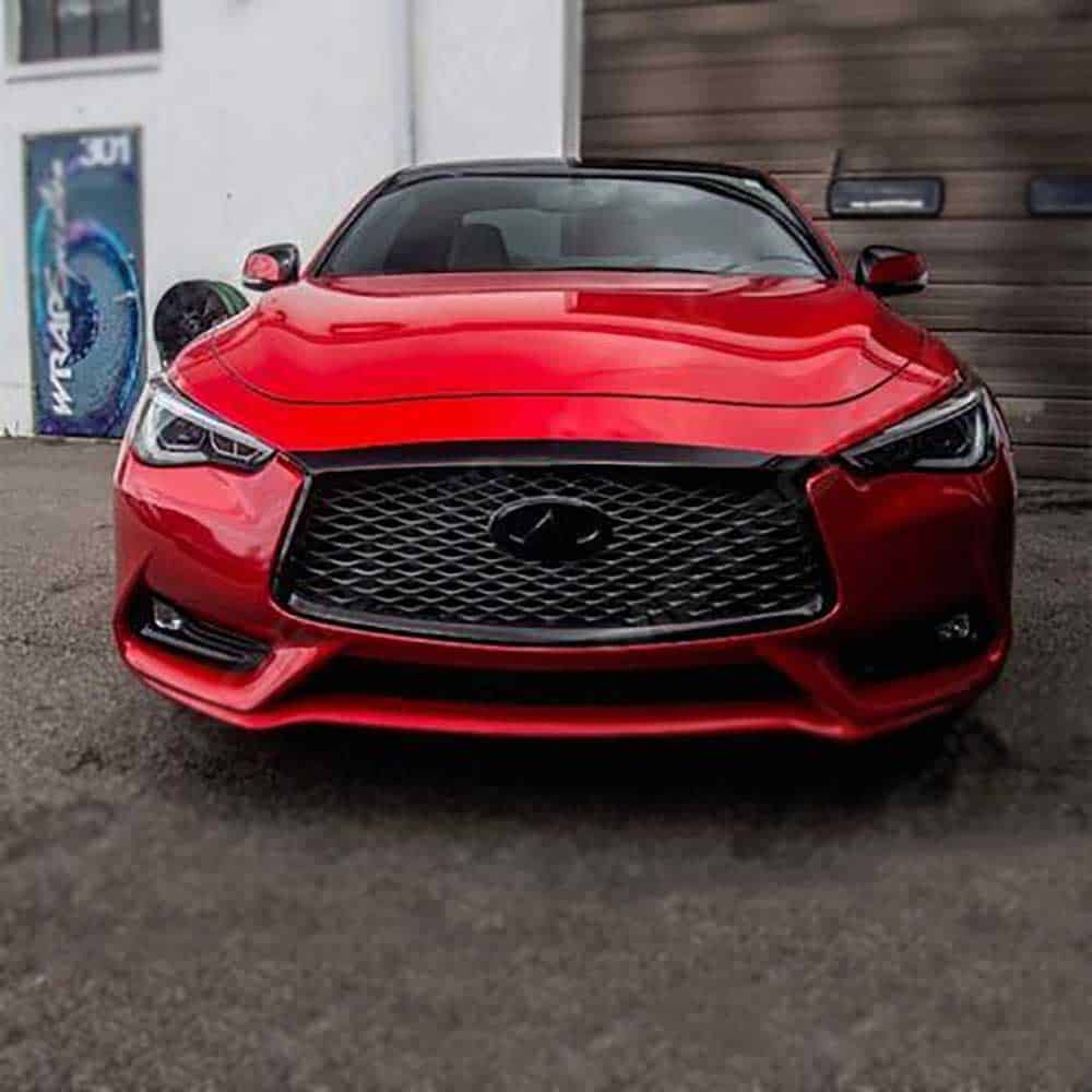 Oracal Gloss Luscious Lips installed on a car parked on a street with a building