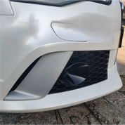 Close-up of a car's front bumper and grille with Oracal matte white vinyl wrap fitted