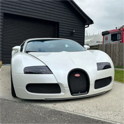 Matt white Oracal vehicle wrap on a Bugatti parked in front of a garage