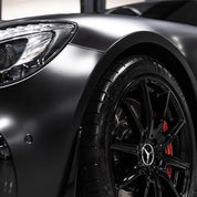 Close-up of a car wheel with super matt vehicle wrap installed