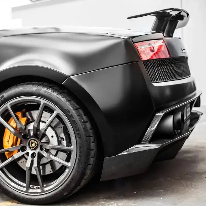Super matt black sports car with a focus on the wheel and front bumper
