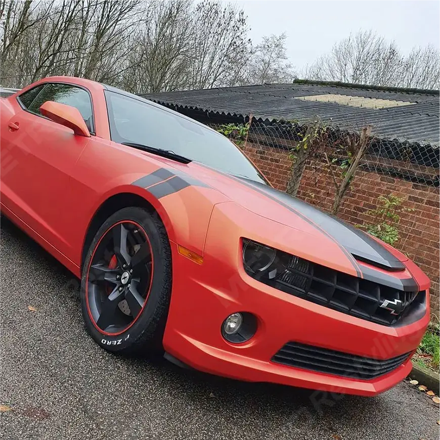 Oracal matt unique sunset vinyl wrap on a sports car with black stripes parked on a driveway