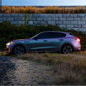 Luxury SUV parked on a dirt road with an Oracal matte pearl symphony car wrap installed