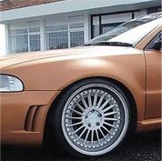 Close up of the front wing of a car with Oracal 970-944M matte red gold L metallic