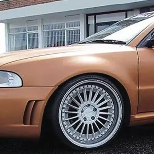 Close up of the front wing of a car with Oracal 970-944M matte red gold L metallic
