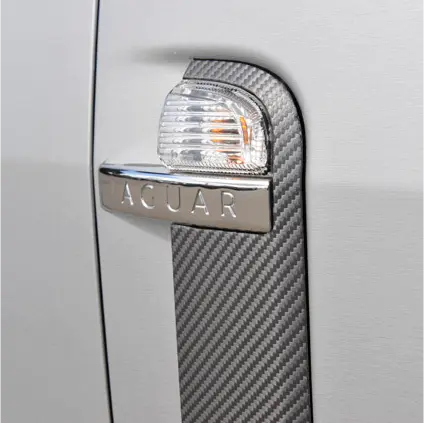 Silver car door handle with Oracal carbon fibre vinyl wrap installed
