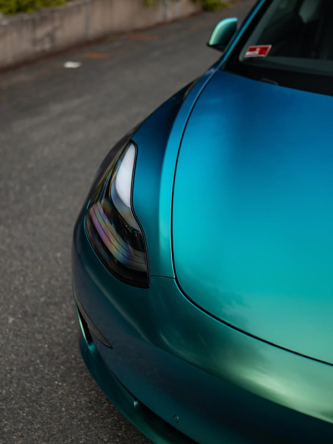 Close-up of an Oracal Gloss Aquamarine installed on a car's headlight and hood