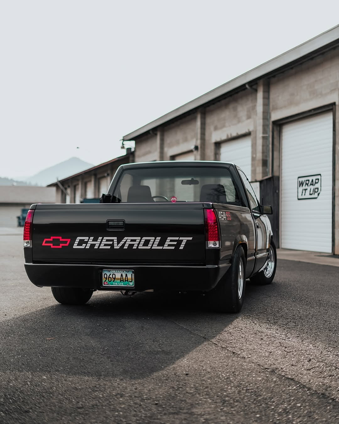 Chevrolet truck parked in front of a building with Oracal Gloss Black installed