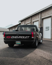 Chevrolet truck parked in front of a building with Oracal Gloss Black installed