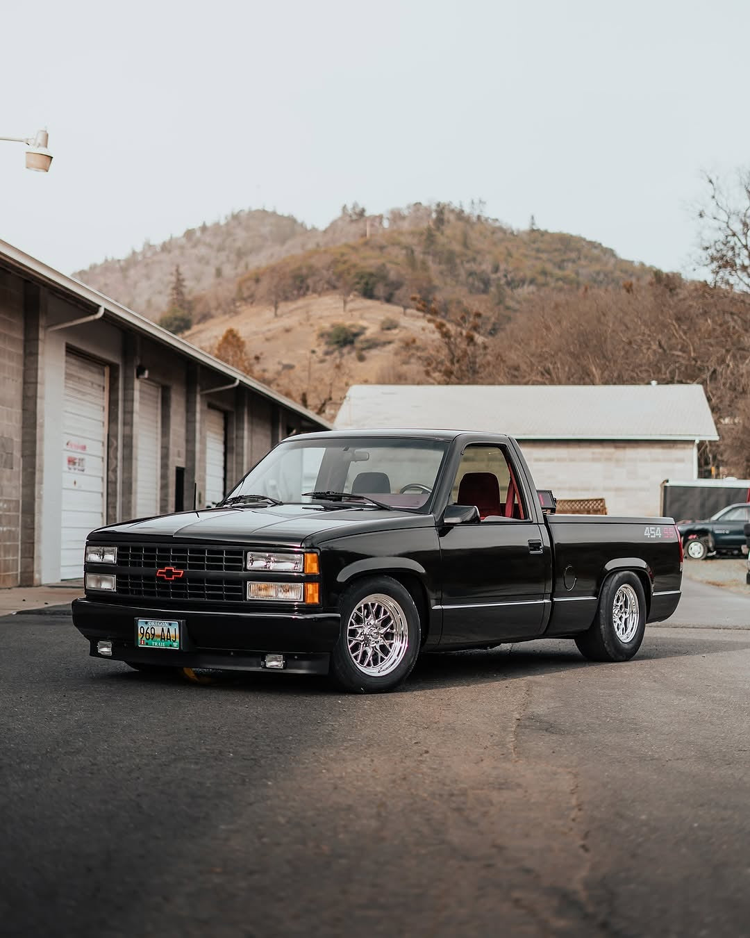 Oracal Gloss Black wrap installed on a pickup truck parked in a lot with mountains 