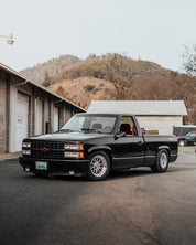 Oracal Gloss Black wrap installed on a pickup truck parked in a lot with mountains 