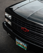 Close-up of an Oracal Gloss Black Chevrolet truck's front grille 
