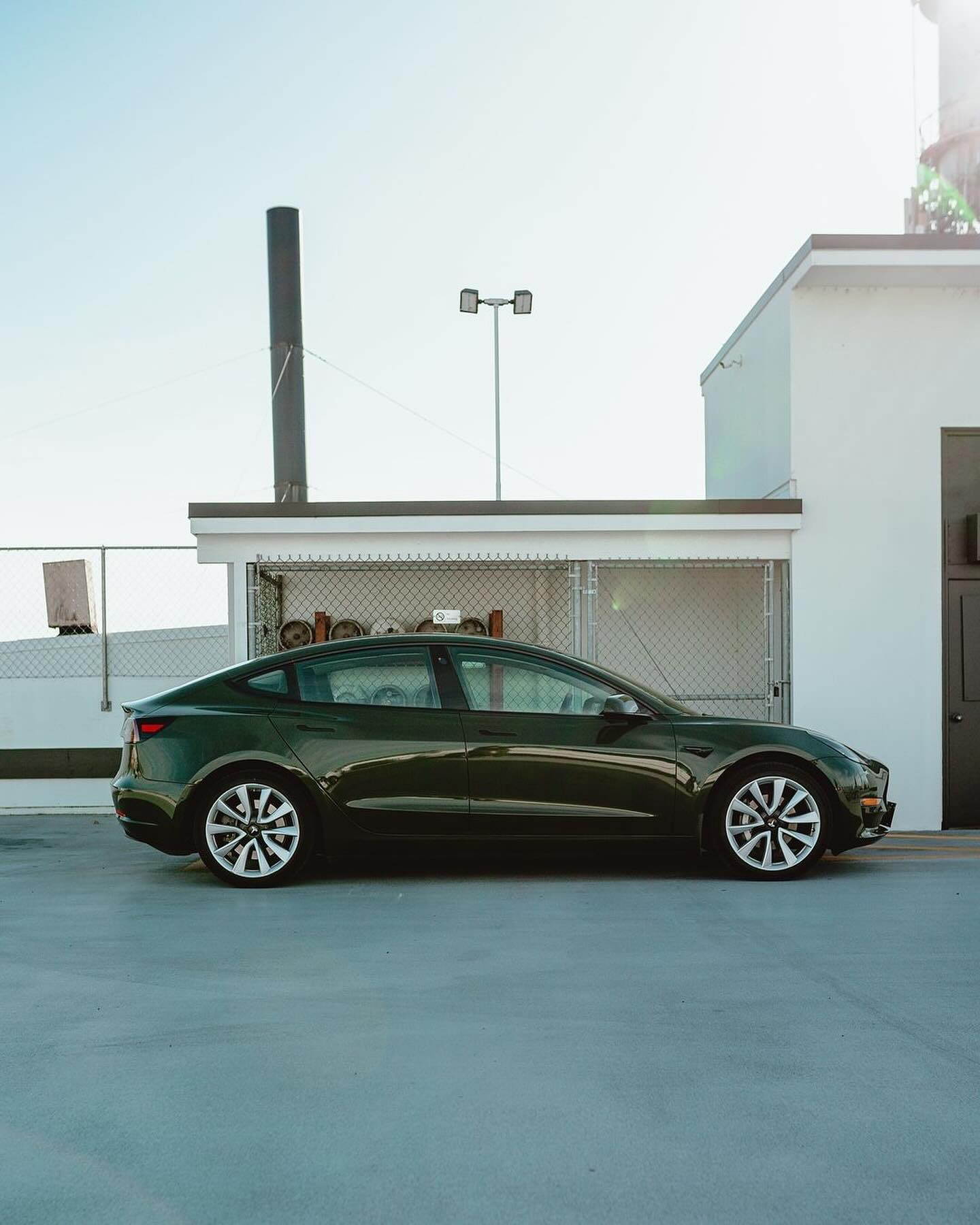 Oracal Gloss Bottle Green electric car parked on a rooftop of a building 