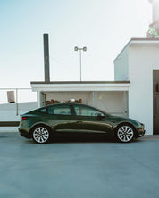 Oracal Gloss Bottle Green electric car parked on a rooftop of a building 