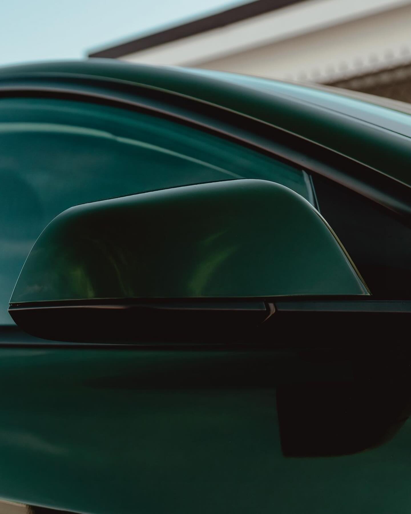 Side mirror of an Oracal Gloss Bottle Green car 
