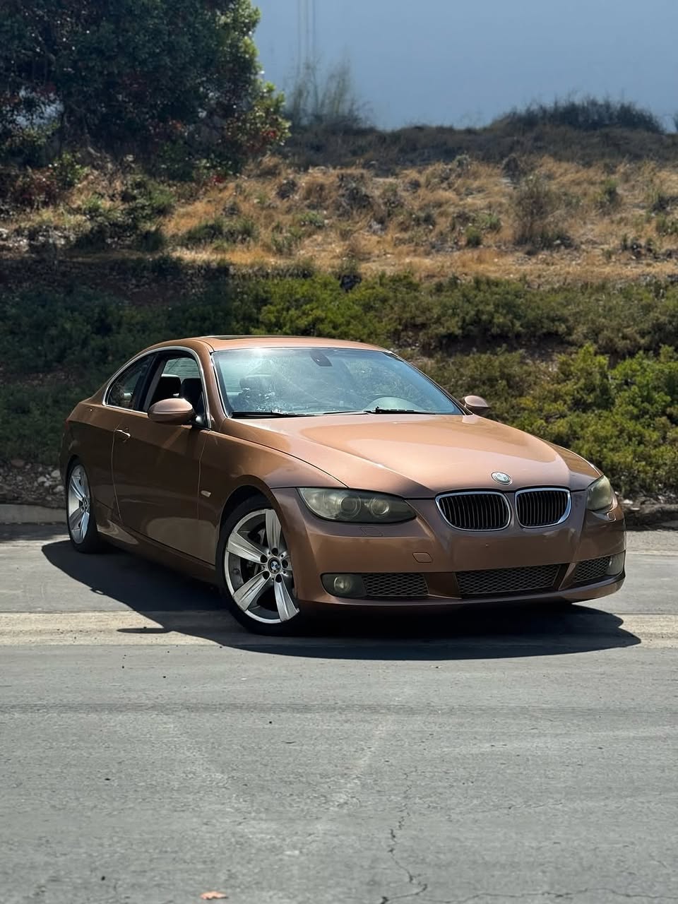 Oracal Gloss Bronze Antique Metallic on a BMW car parked on a road