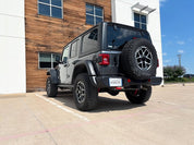 Oracal Gloss Charcoal Metallic installed on a Jeep parked in a parking lot with a building