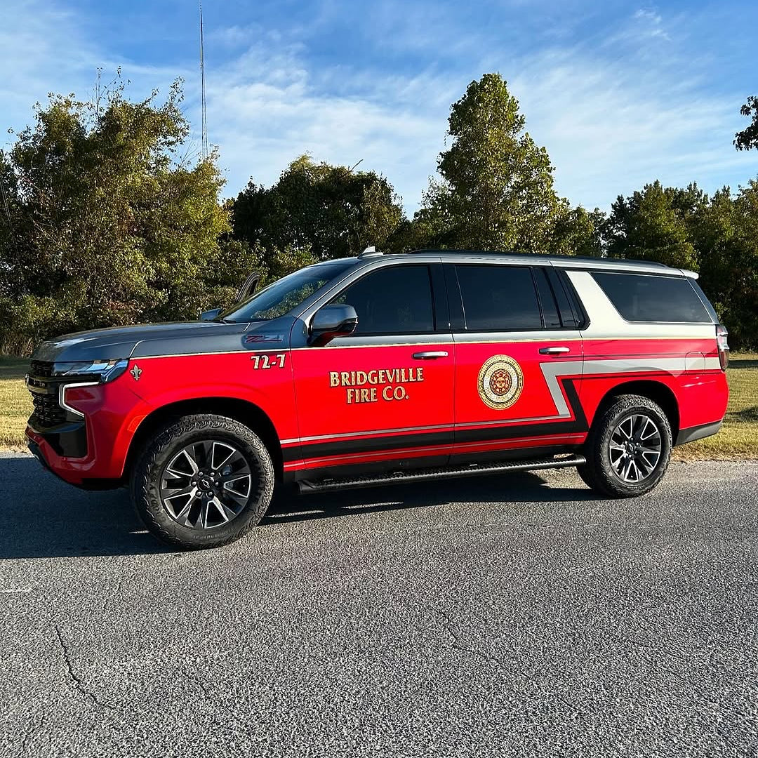 Oracal Gloss Chili Red installed on a car which is parked outside