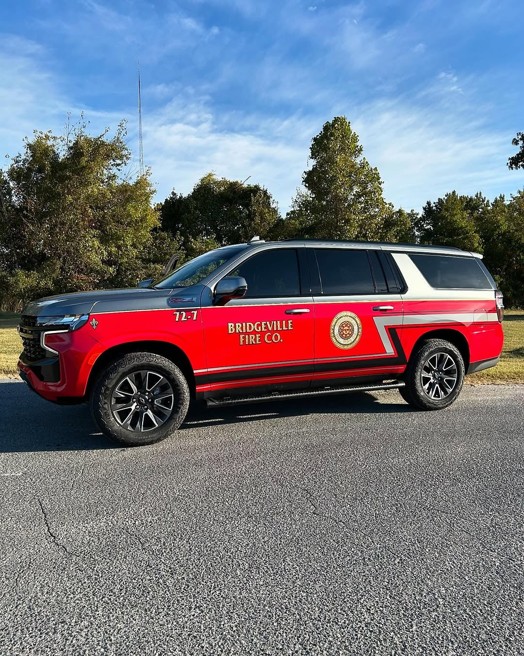 Oracal Gloss Chili Red installed on a car which is parked outside