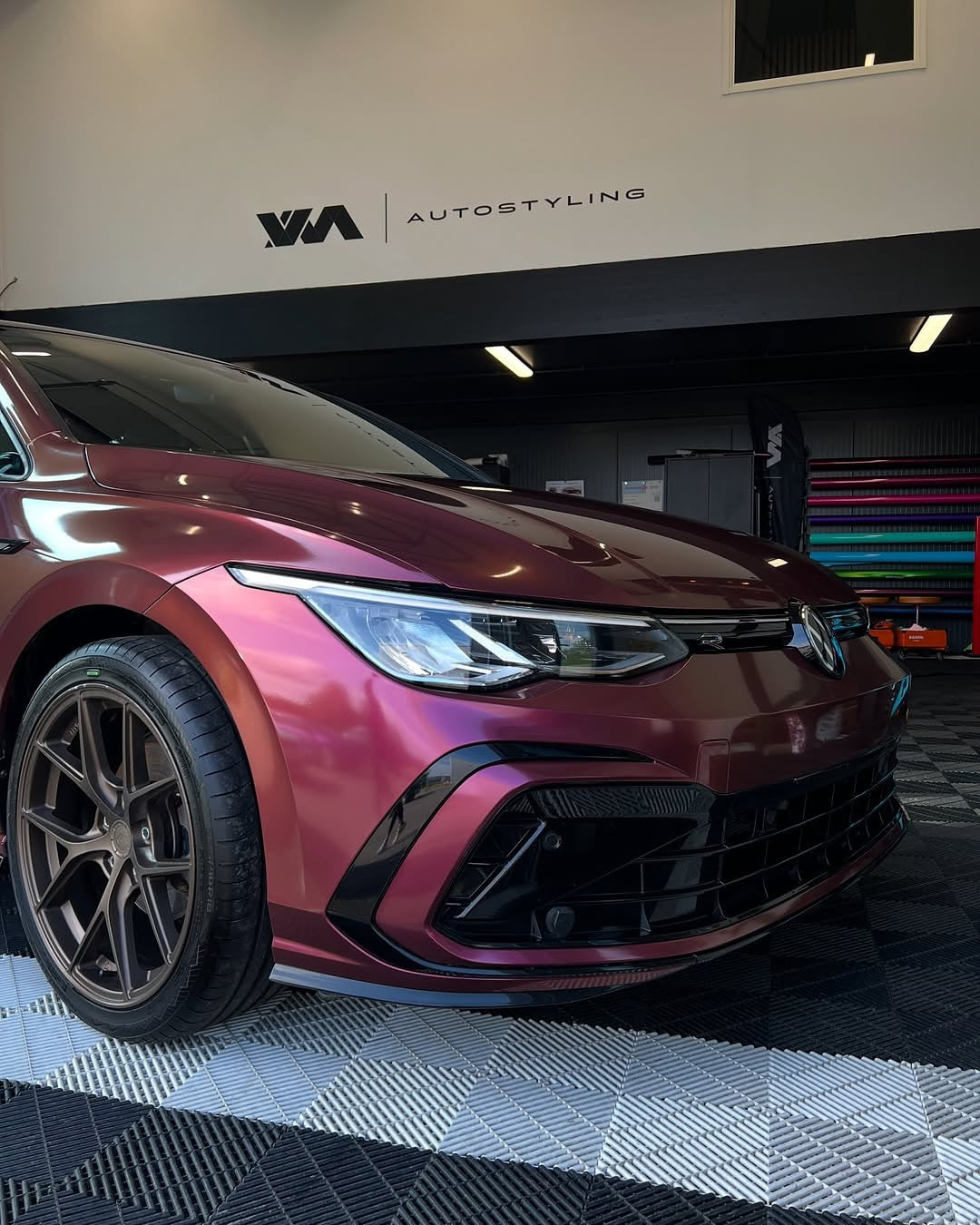 Oracal Gloss Cranberry car on a lift in a garage