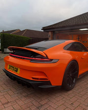 Oracal Gloss Daggi Orange sports car parked on a driveway with a house