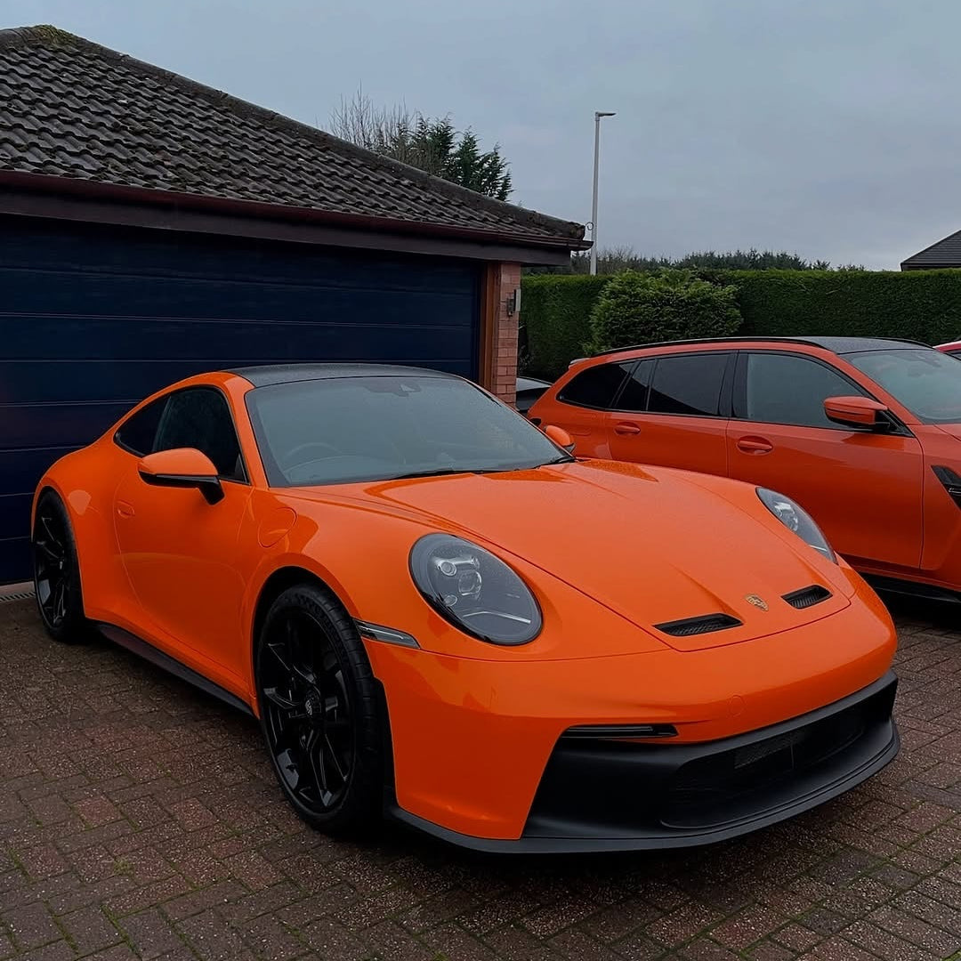Oracal Gloss Daggi Orange sports car parked on a driveway