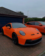 Oracal Gloss Daggi Orange sports car parked on a driveway