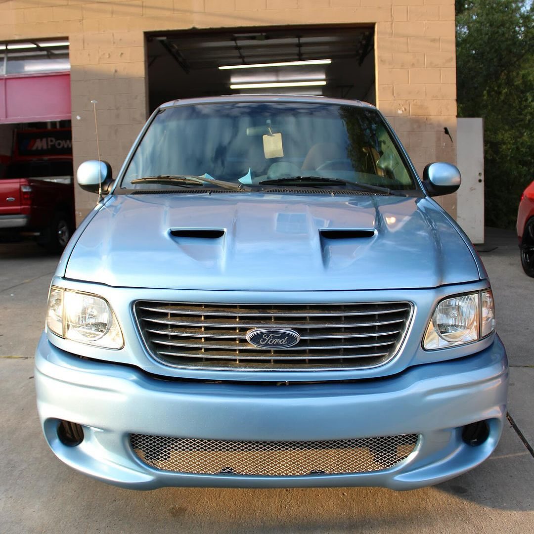 Oracal Gloss Dove Blue Metallic Ford truck parked in front of a garage