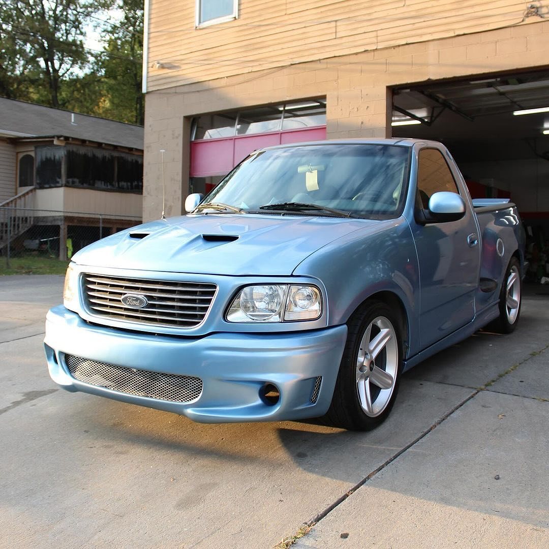 Oracal Gloss Dove Blue Metallic pickup truck parked in front of a building